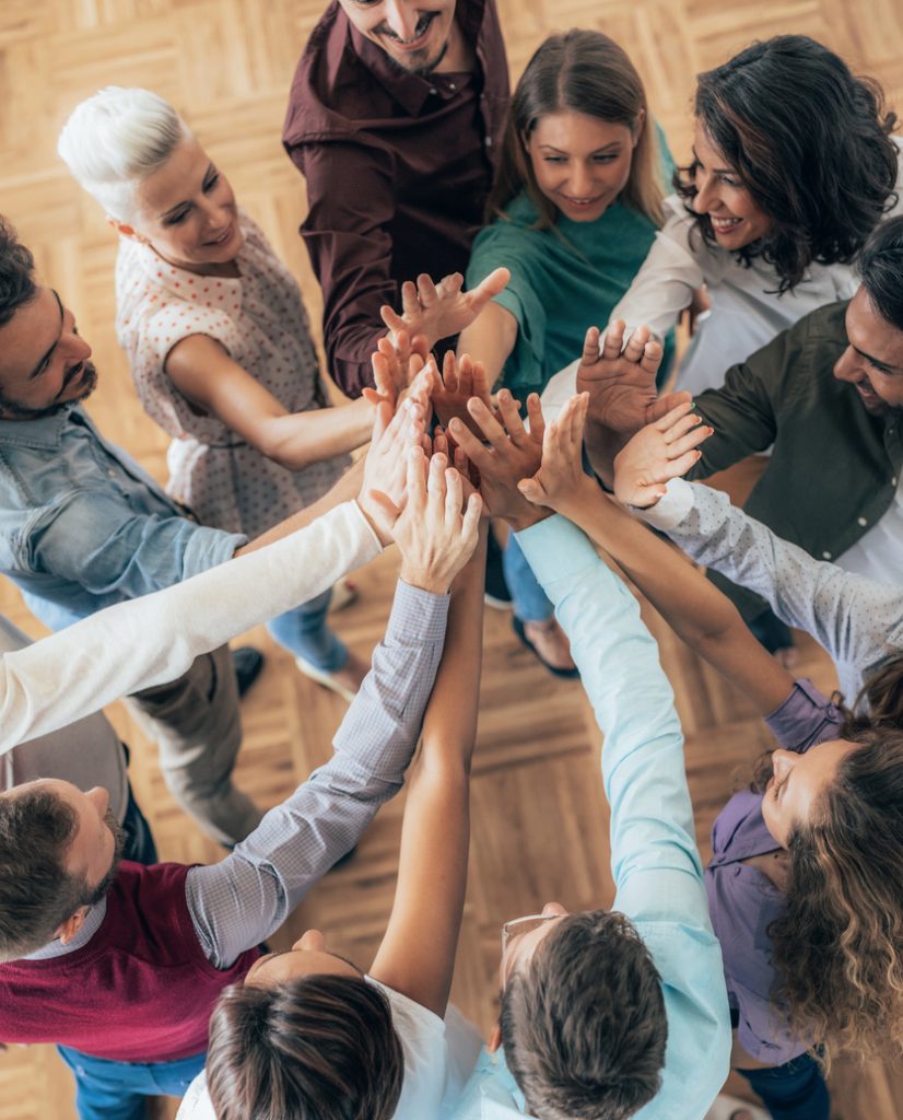 Shot of diverse business people stacking their hands on top of each other, in circle
